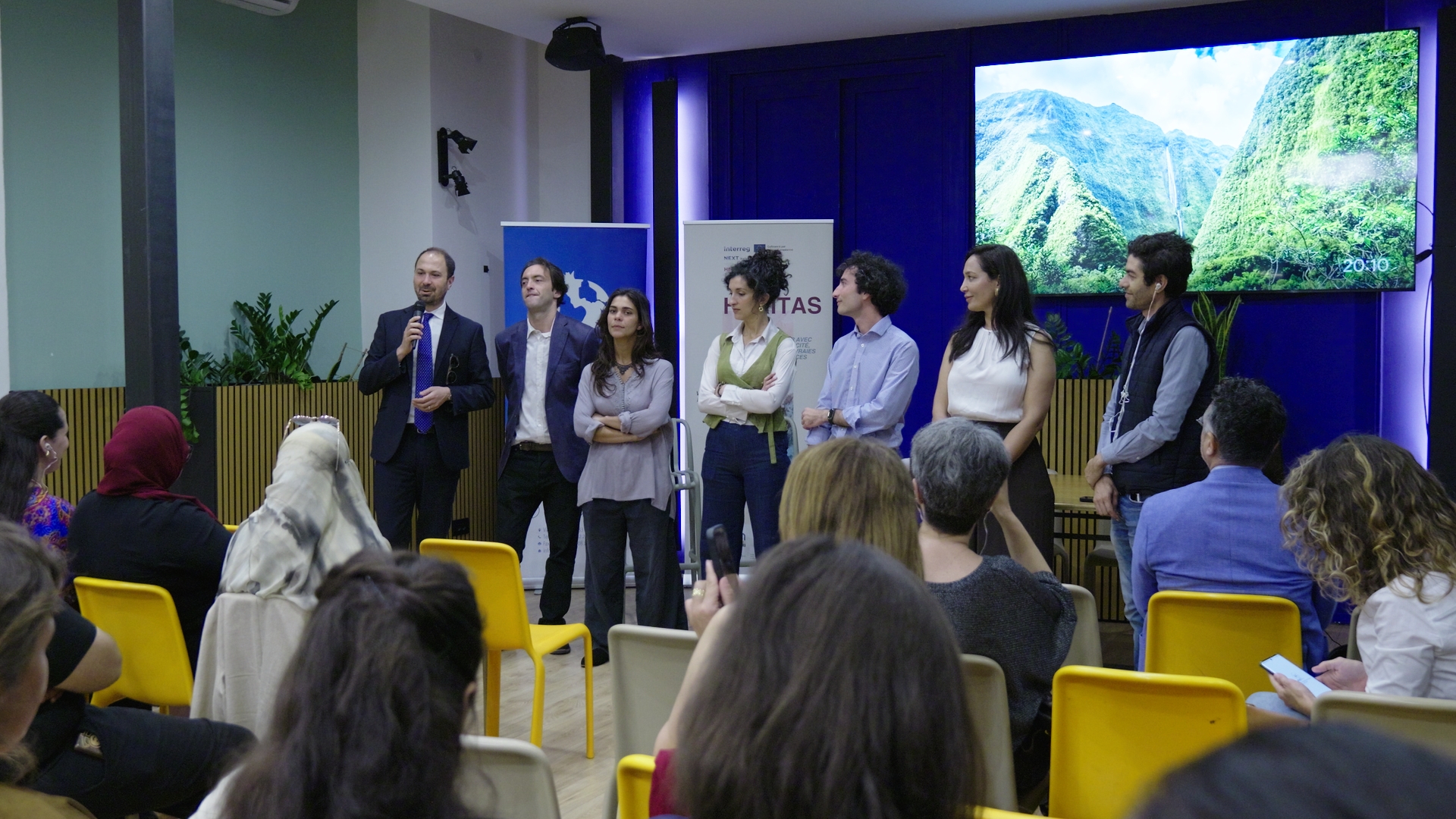 Sept personnes prennent la parole devant le groupe de participant·e·s de l’Atelier International HERITAS à Palerme.